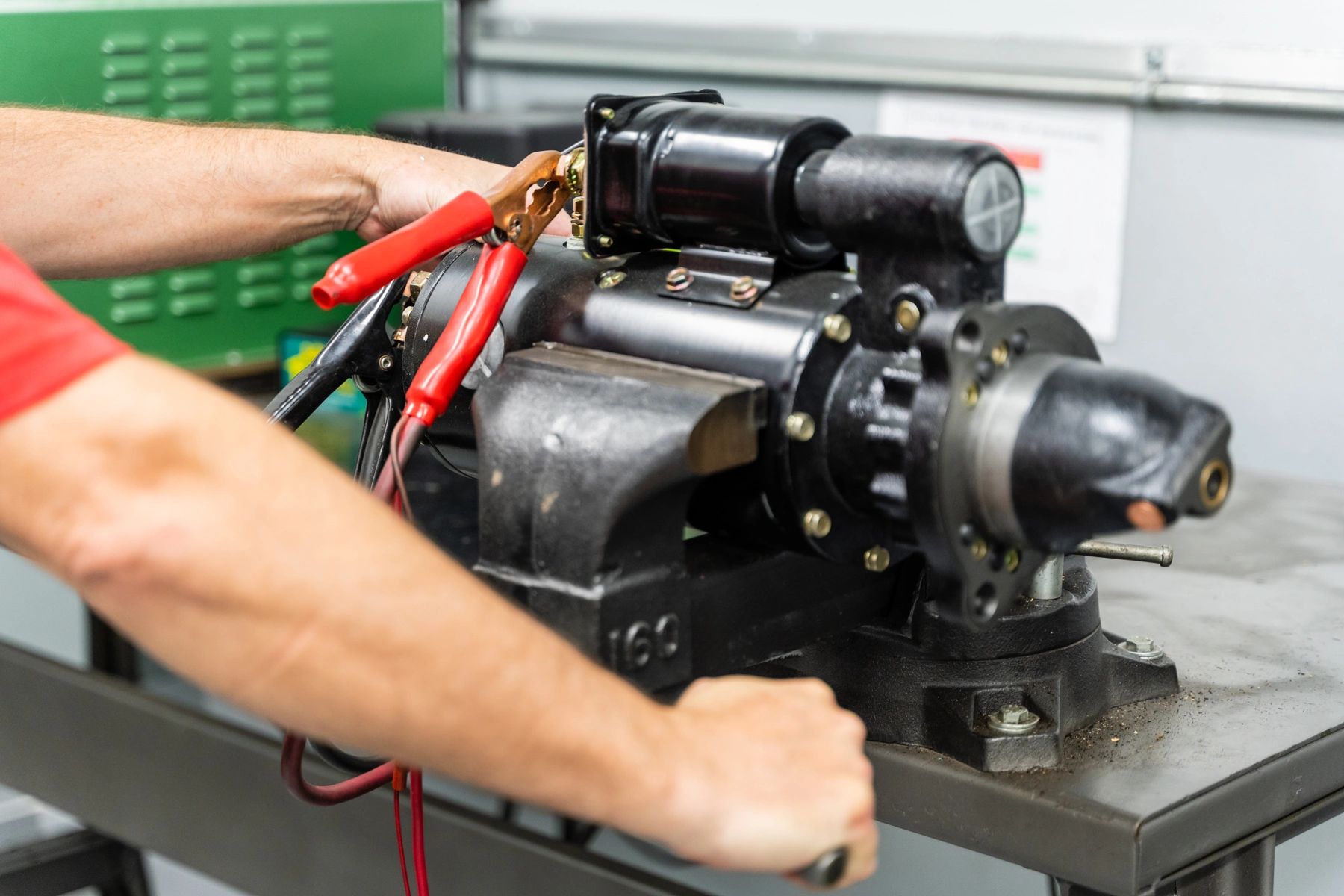 Technician testing an industrial pump motor component